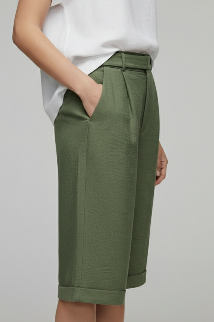 Model wearing women's high-waist cuffed shorts, showcasing their flattering fit and casual style.
