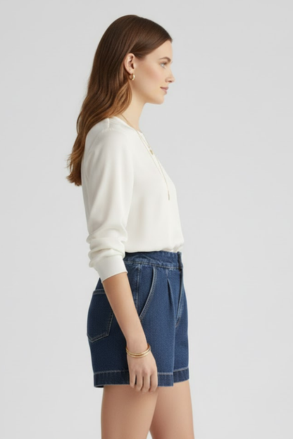 Close-up of women's denim high waisted shorts with a neatly rolled hem, ideal for summer.