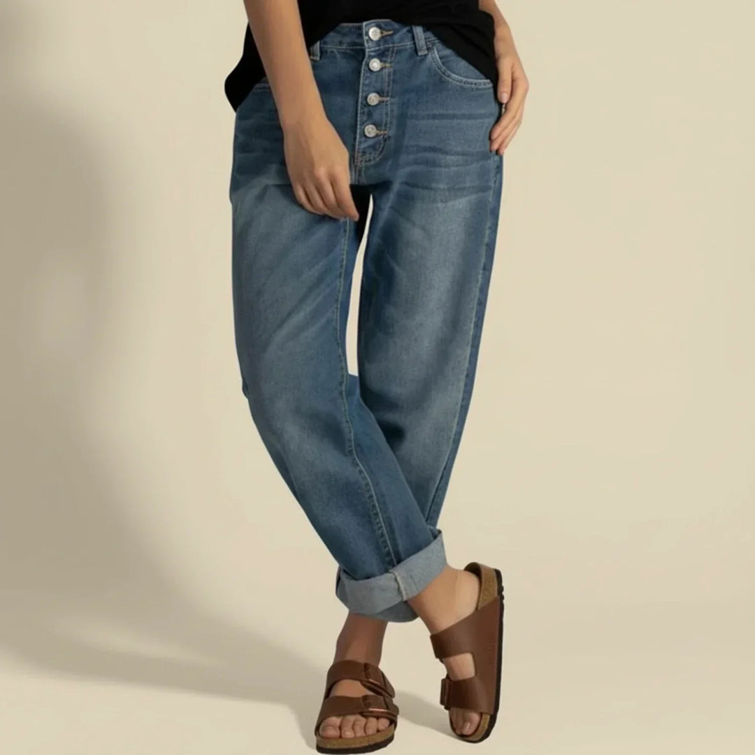 Classic style women's high-waisted blue jeans featuring a prominent button fly closure, ideal for everyday wear.