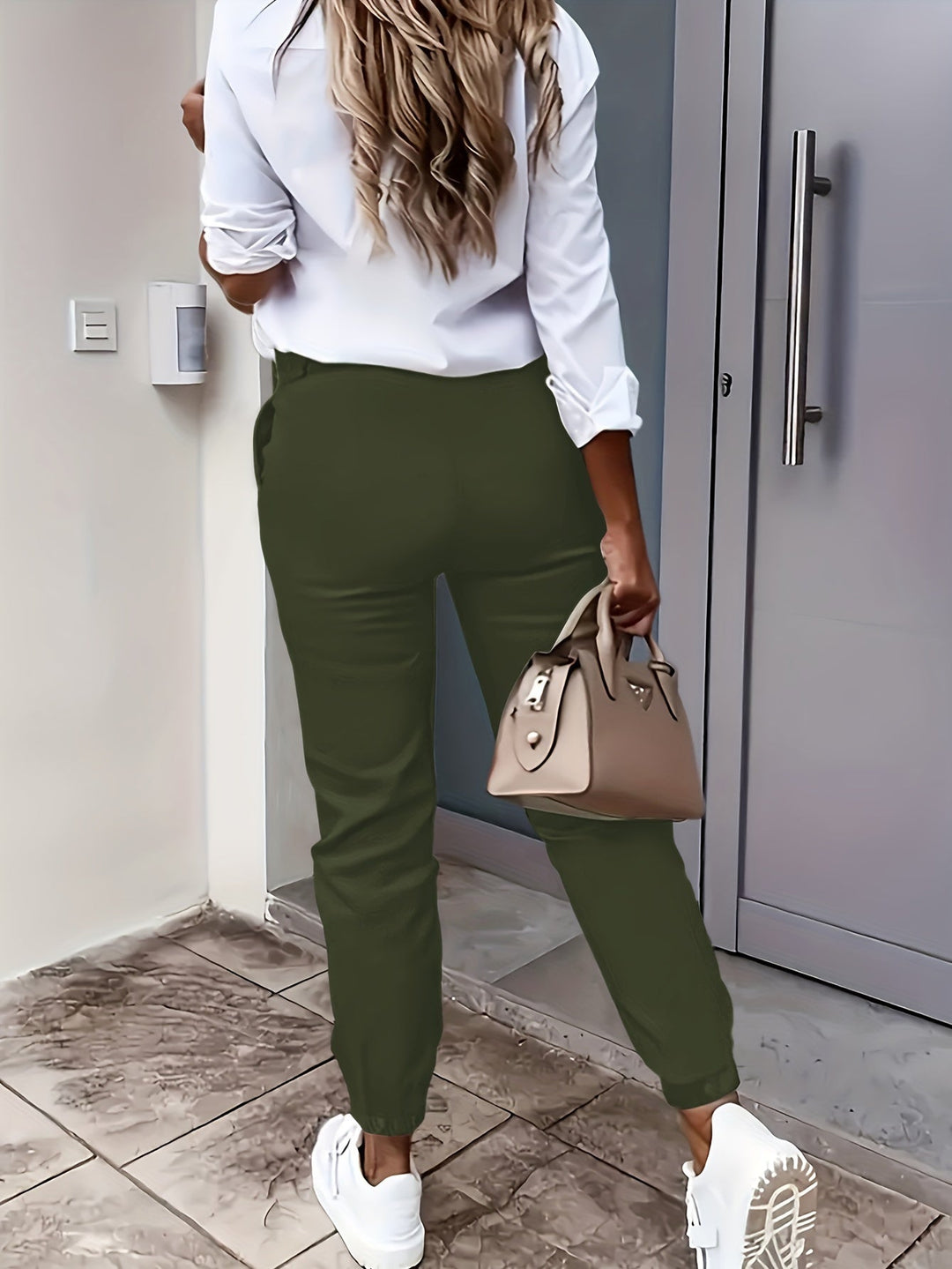 Women's high-waisted tapered dress pants in white, clean and modern design for professional look.