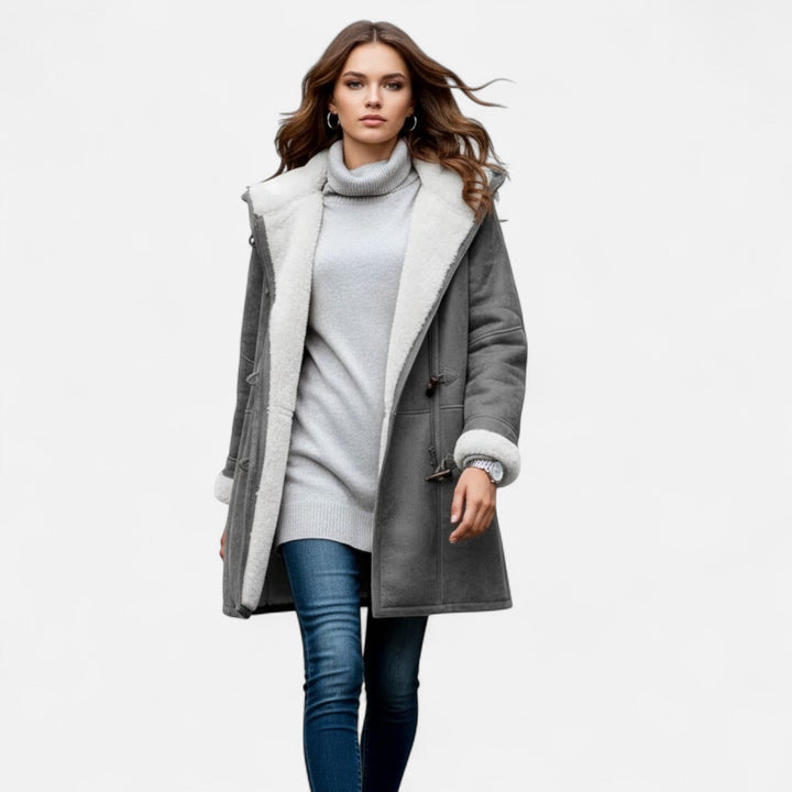 Chic women's hooded button-front winter coat, featuring pockets and a long, warm design.