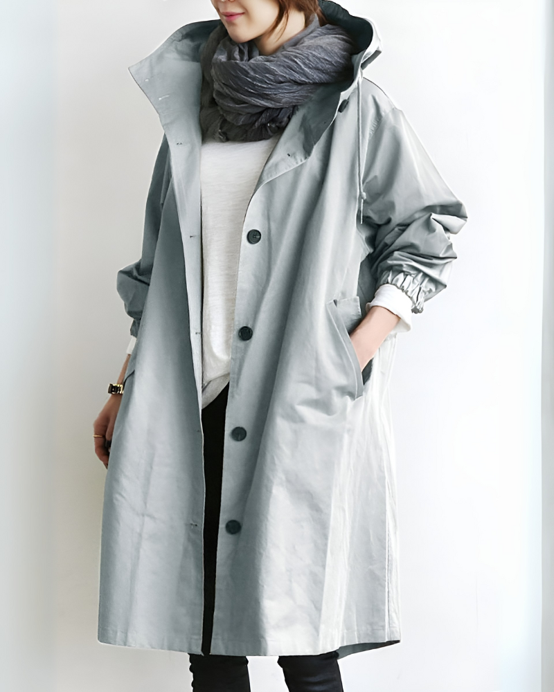 Close up of women's hooded loose fit trench coat fabric, showing polyester texture.