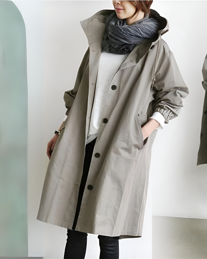 Stylish women's autumn outerwear: a hooded loose fit trench coat with single breasted closure.