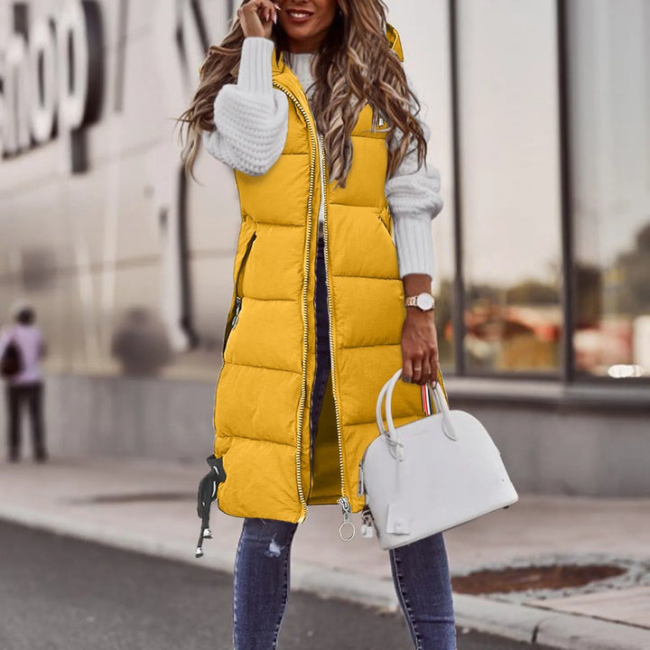 Comfortable women's hooded padded vest offering superior winter warmth & modern style. Essential casual outerwear.