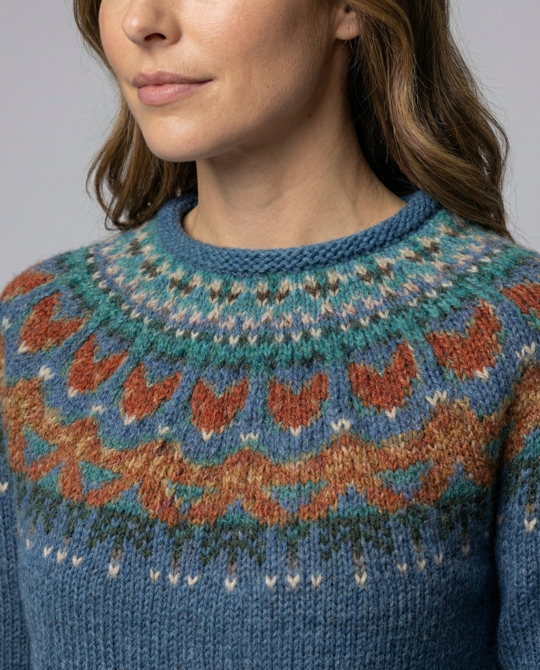Stylish woman wearing a warm Icelandic knit sweater, exuding cozy vintage charm for winter fashion.