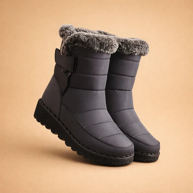 Black women's ankle-height winter boots, insulated for warmth & designed for outdoor slip resistance.