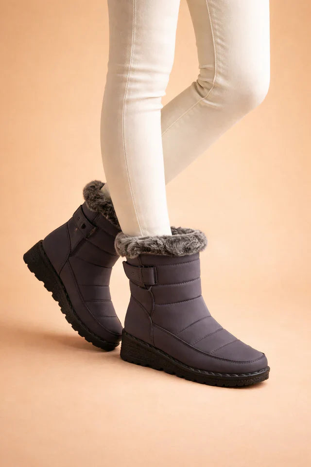 Blue women's insulated snow boots, featuring a warm lining and a durable anti-slip sole for winter comfort.