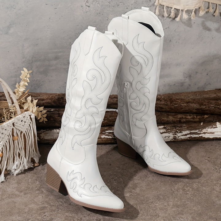 Detailed shot of the block heel on women's knee-high western boots, durable and chic.