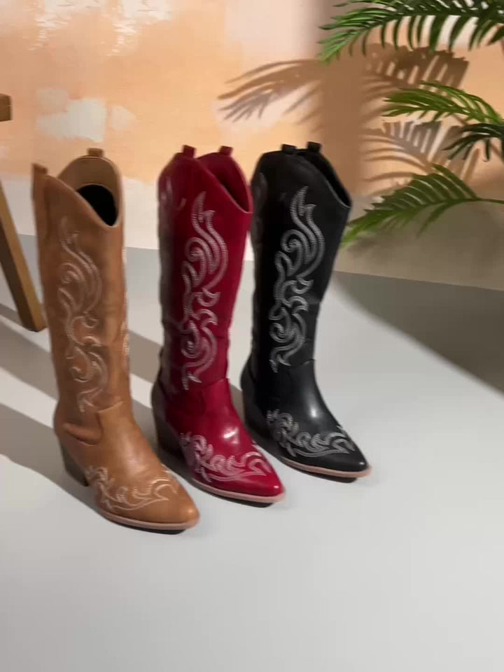 Women's black knee-high cowboy boots featuring intricate western stitching and a stylish block heel.
