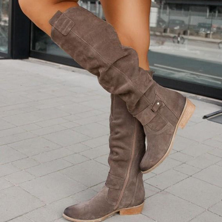 Black women's riding boots, knee-high with decorative buckles and functional side zipper detail