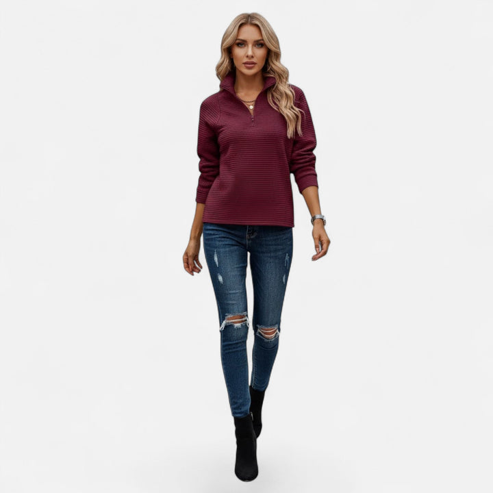 Women's warm knit sweater with a stand-up collar and a sleek quarter-zip design.