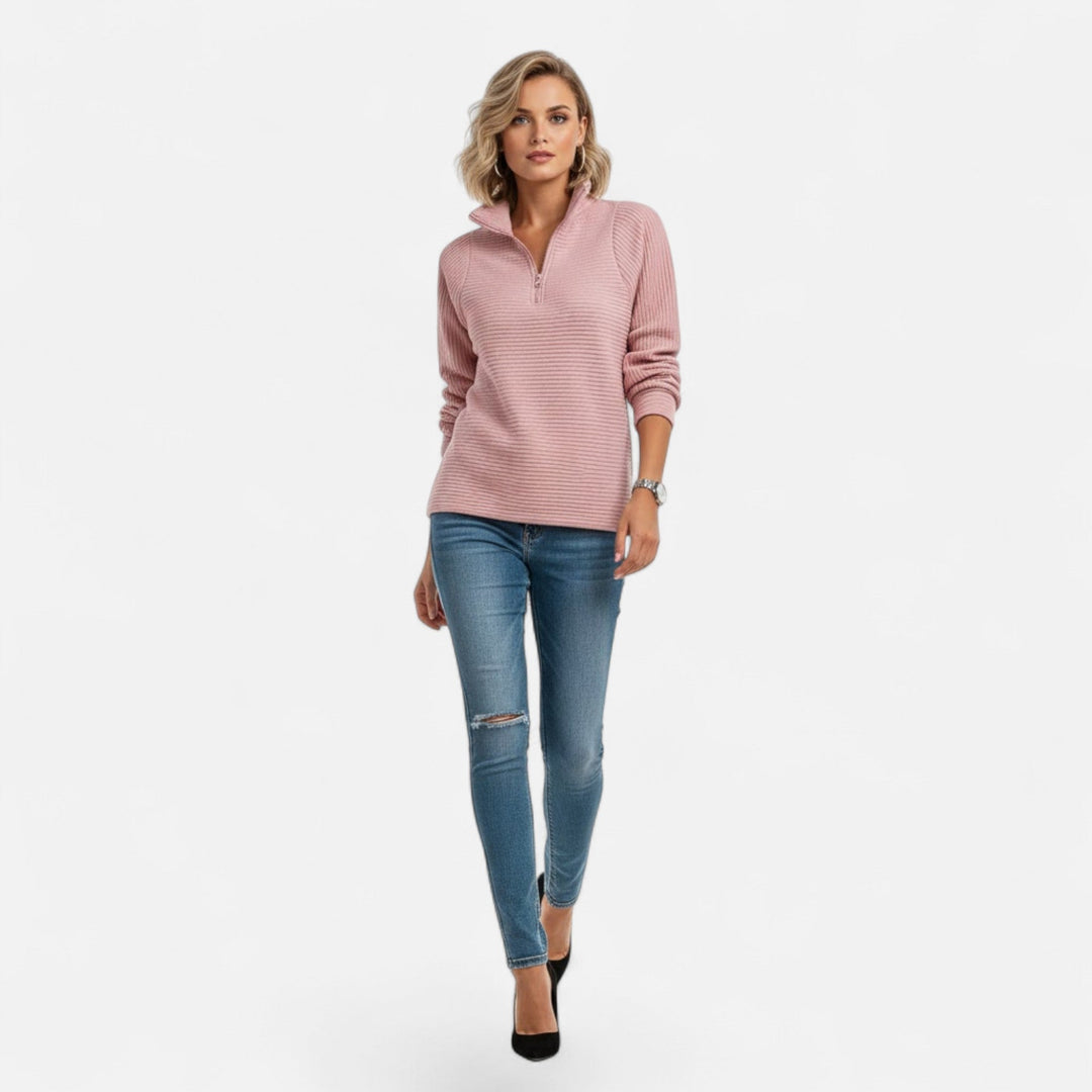 Women's soft knit sweater with a prominent stand-collar and half-zip opening.