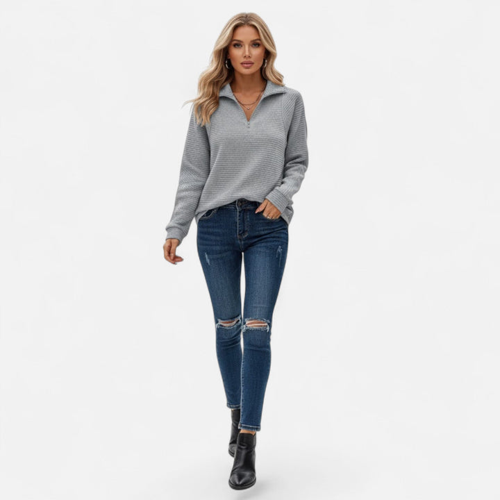 Women's elegant knit sweater with a stand-collar zipper, ideal for cool spring evenings.