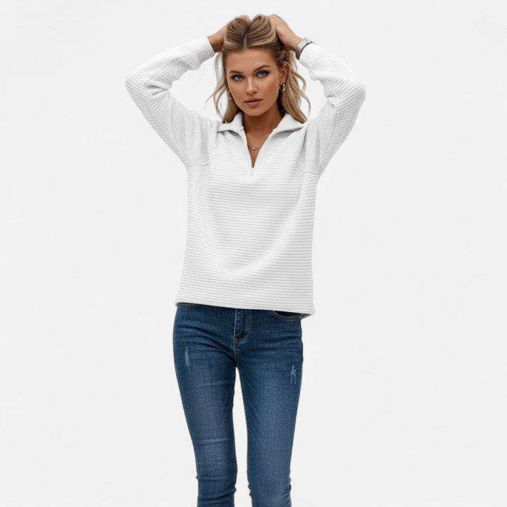 Close-up of a cozy women's knit sweater featuring a chic stand-collar and zipper detail.