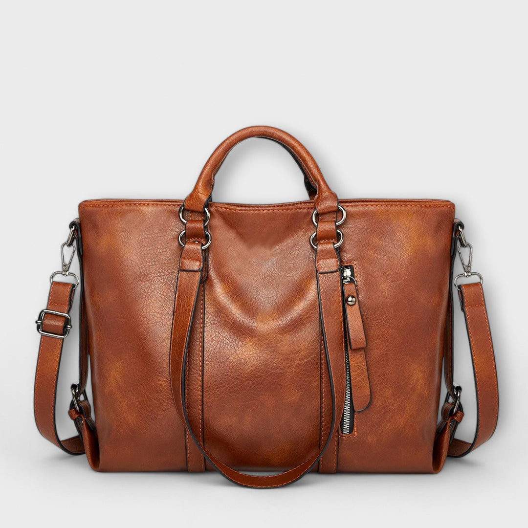 Women's large leather tote handbag in a neutral color, perfect for everyday use or travel.