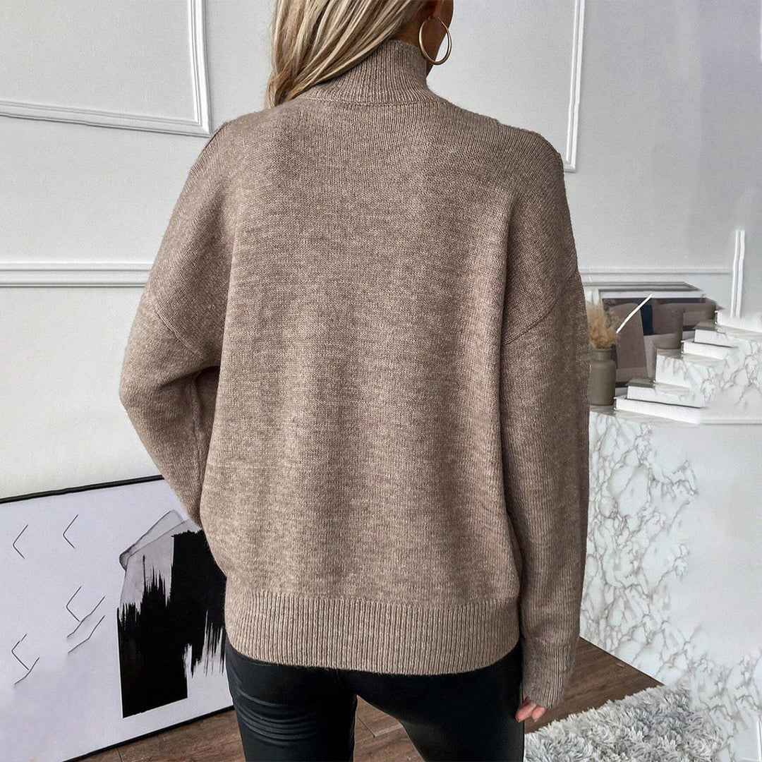 Casual long sleeve knitwear: a women's cold shoulder, layered turtleneck sweater.
