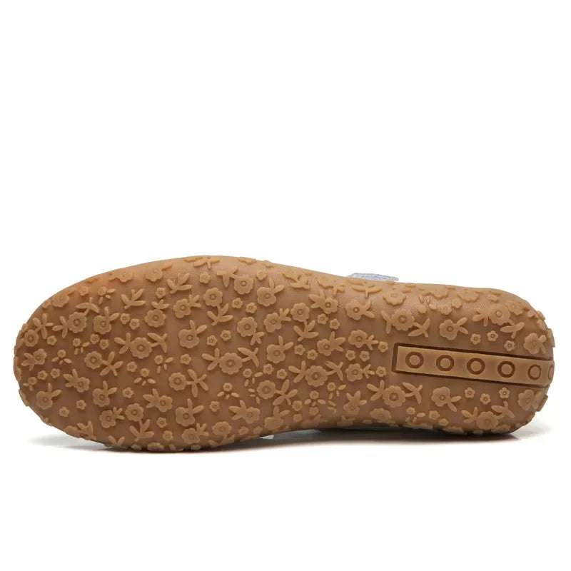 Woman's foot in comfortable leather open-toe sandals with adjustable Velcro, ready for active summer days.