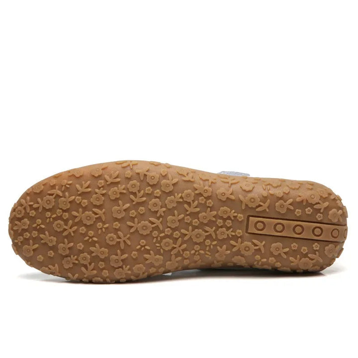 Woman's foot in comfortable leather open-toe sandals with adjustable Velcro, ready for active summer days.