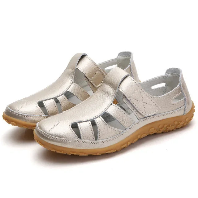 Woman walking comfortably in adjustable leather Velcro sandals, perfect for active summer days & adventures.
