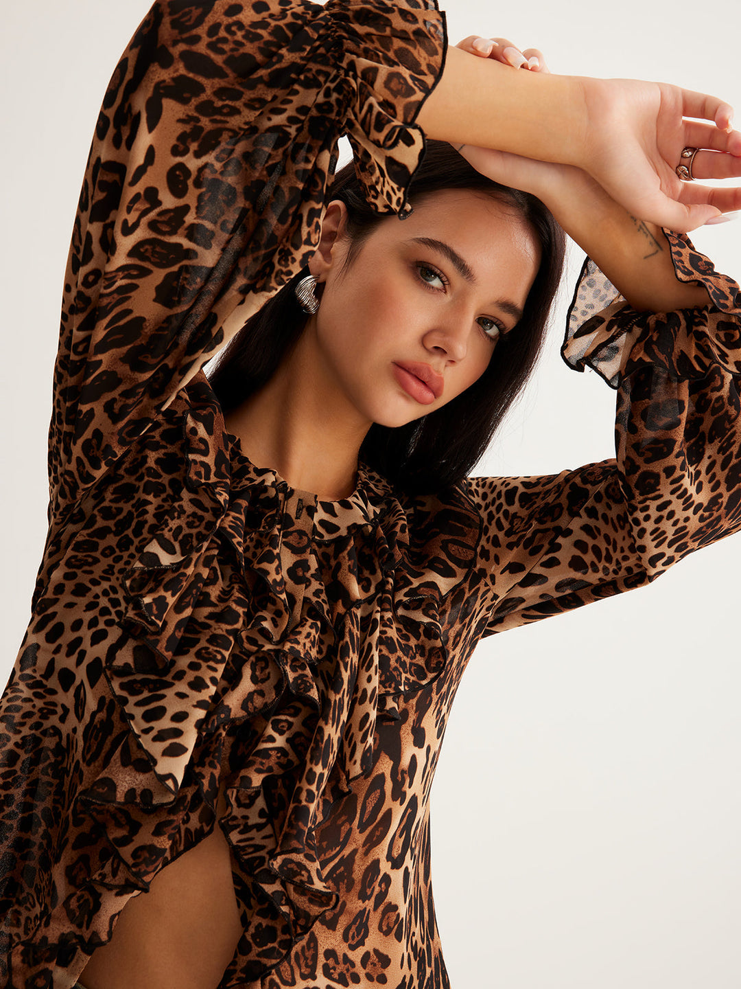 Casual women's blouse, leopard print pattern, and elegant ruffle neckline