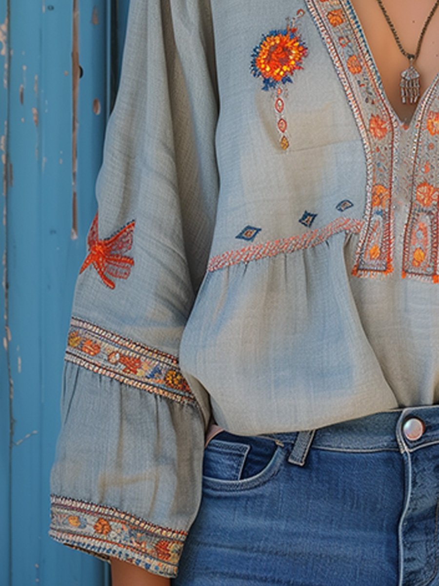 Elegant women's embroidered blouse, light blue with a flattering V-neck design