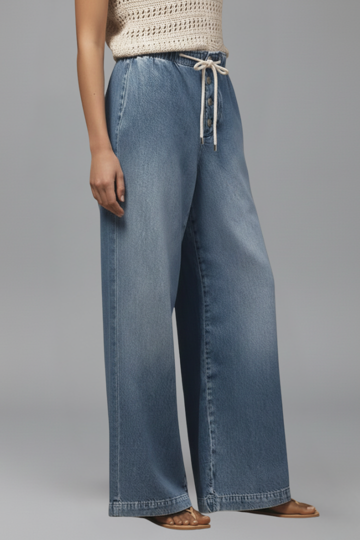 Relaxed fit light blue denim jeans for women, wide-leg style with a functional drawstring.
