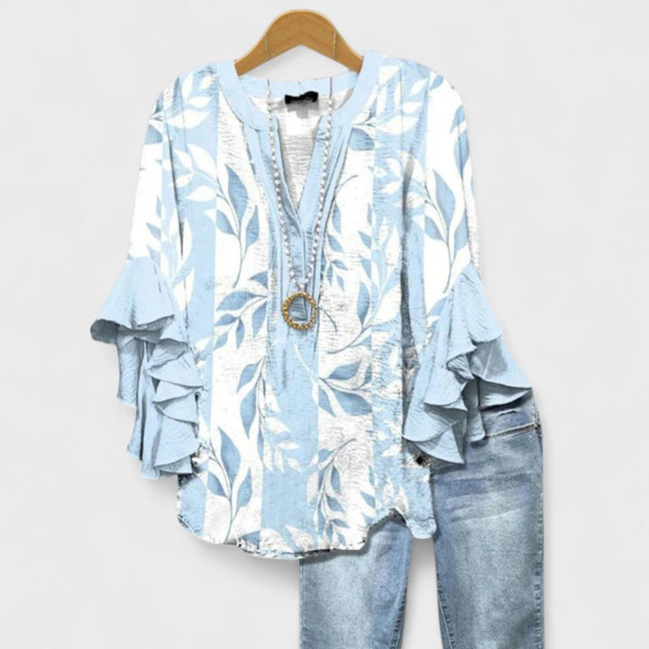 Elegant women's floral print blouse, a lightweight v-neck top with stylish ruffled sleeves.