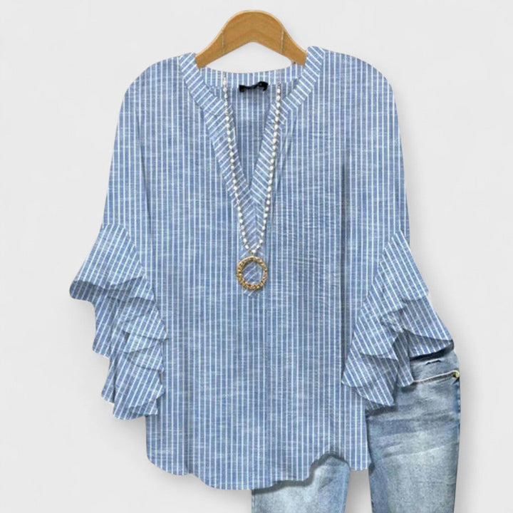 Spring fashion lightweight floral blouse for women, featuring a V-neck and delicate ruffled sleeves.