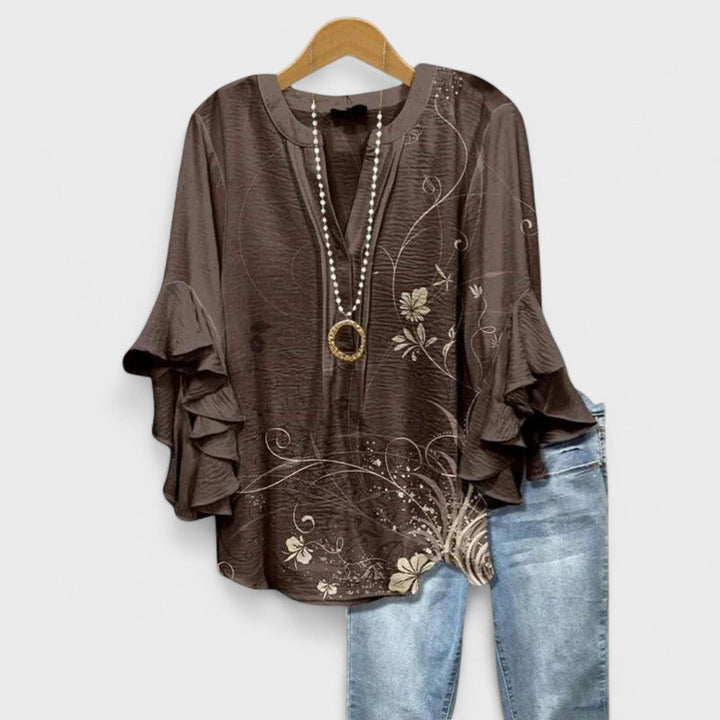 Casual everyday women's top: floral print, lightweight fabric, v-neck, and ruffled sleeves.