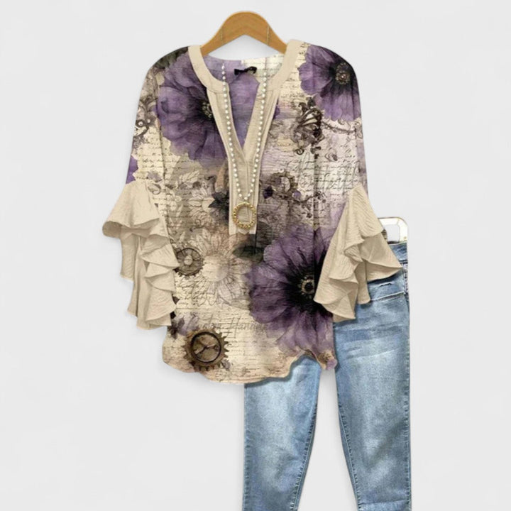 Descriptive image of a women's lightweight floral blouse with a flattering V-neck and ruffled sleeves.