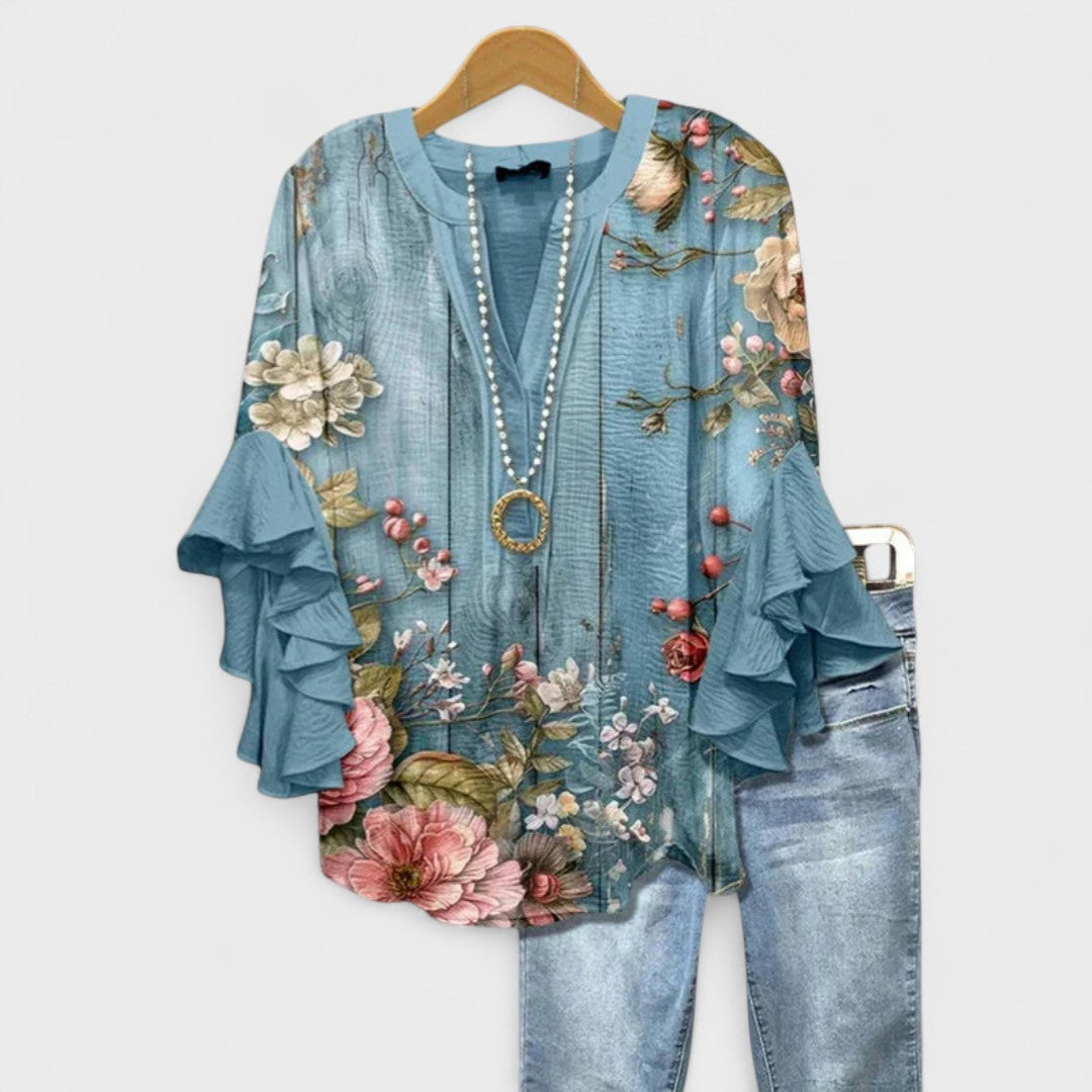 Vibrant floral print women's blouse, a lightweight top with comfortable ruffled sleeves, ideal for day.