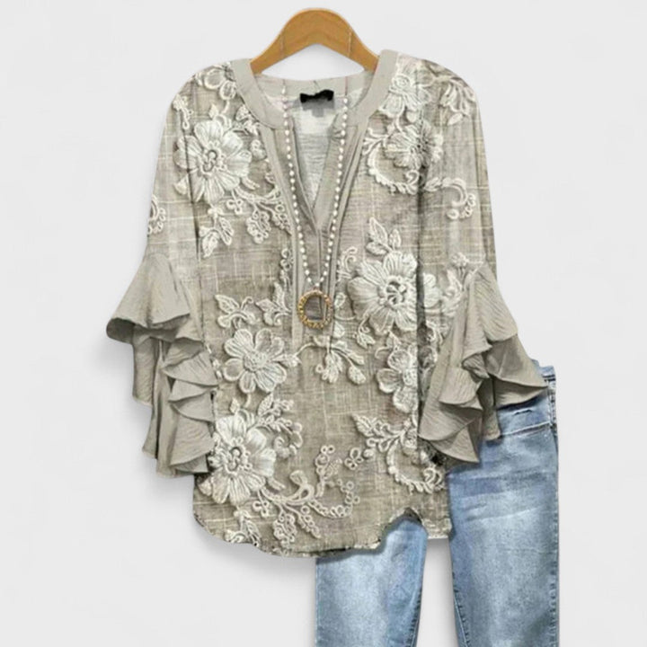 Stylish women's lightweight blouse, floral pattern, V-neck design, and elegant ruffled sleeves.