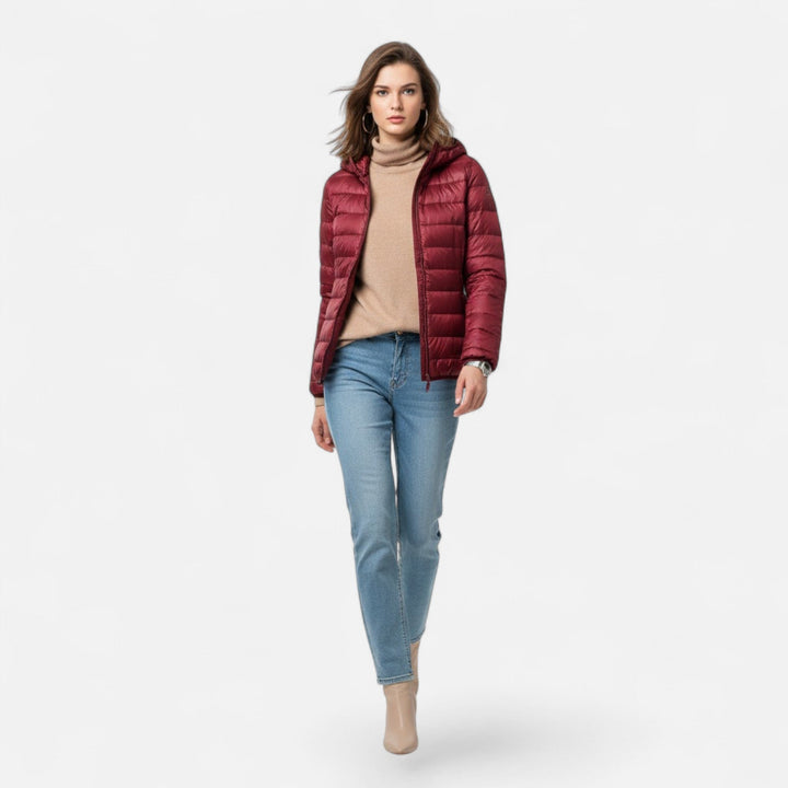 Cold weather women's coat, lightweight, insulated, and hooded, offering warmth and elegance.