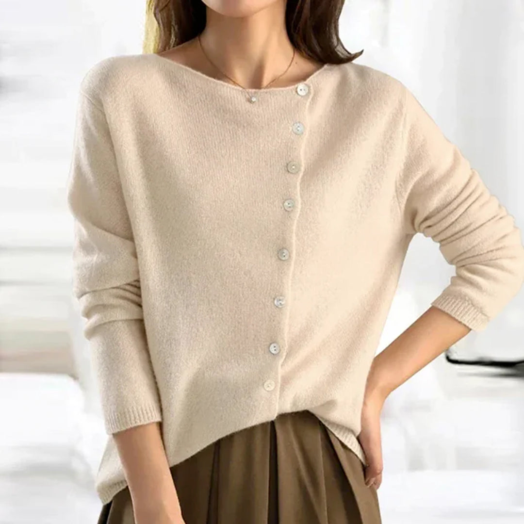 Close-up of a women's lightweight knit cardigan, highlighting the button detail on soft, stretchy fabric.