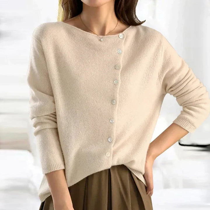 Close-up of a women's lightweight knit cardigan, highlighting the button detail on soft, stretchy fabric.