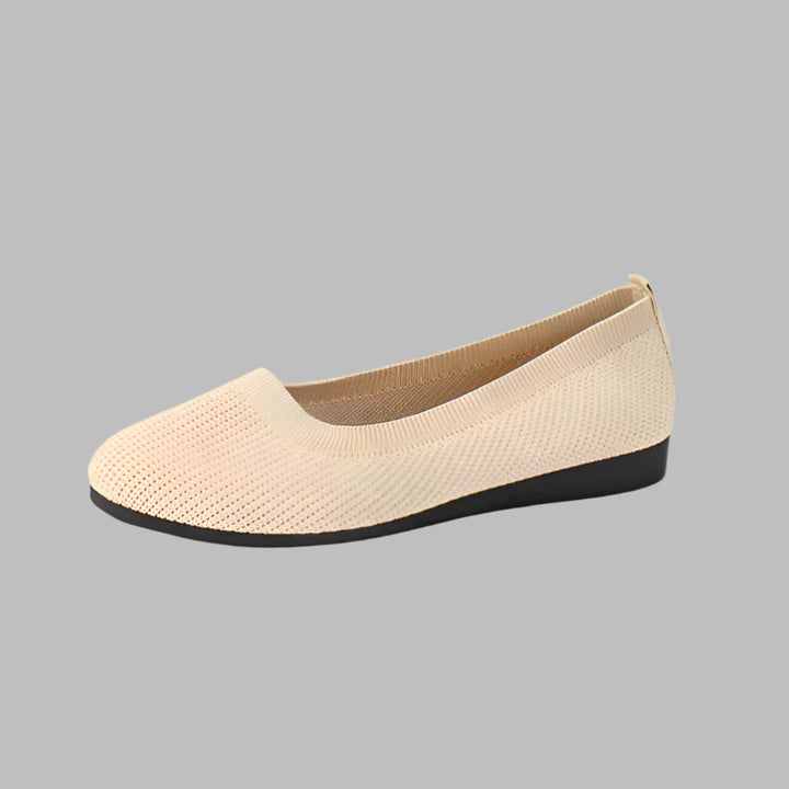 Woman walking outdoors in black lightweight orthopedic slip-on summer shoes, perfect for strolls.