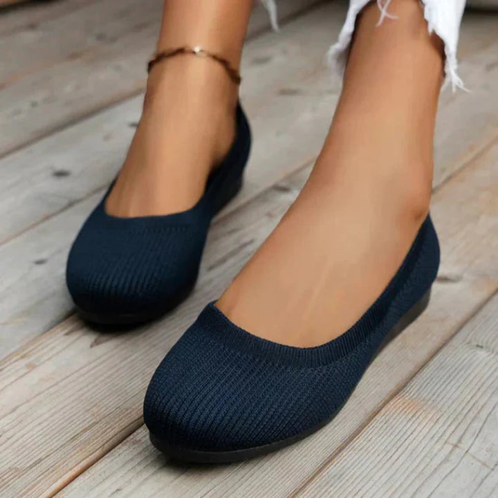 Woman wearing white lightweight orthopedic slip-on summer shoes, demonstrating casual style and comfort.
