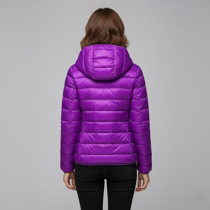 Women's hooded puffer jacket in a deep red, standing out in winter fashion