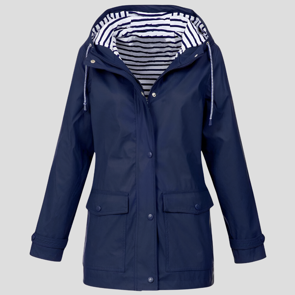 Woman hiking in a versatile, windproof hooded jacket, staying dry and comfortable.