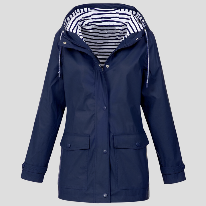 Woman hiking in a versatile, windproof hooded jacket, staying dry and comfortable.