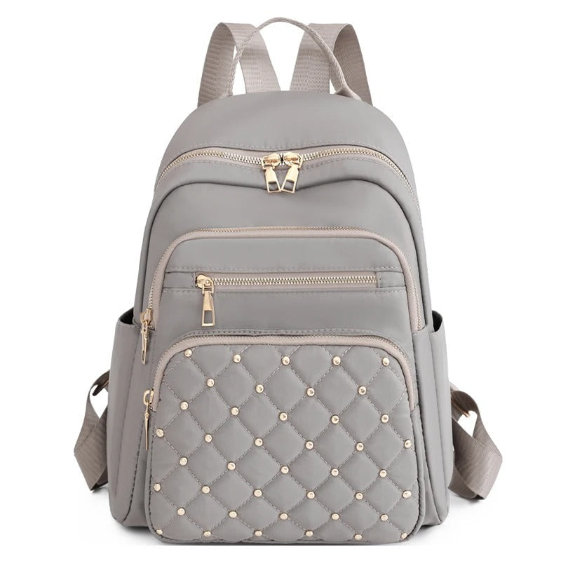 Black women's lightweight water-resistant nylon school backpack for students & commuters.