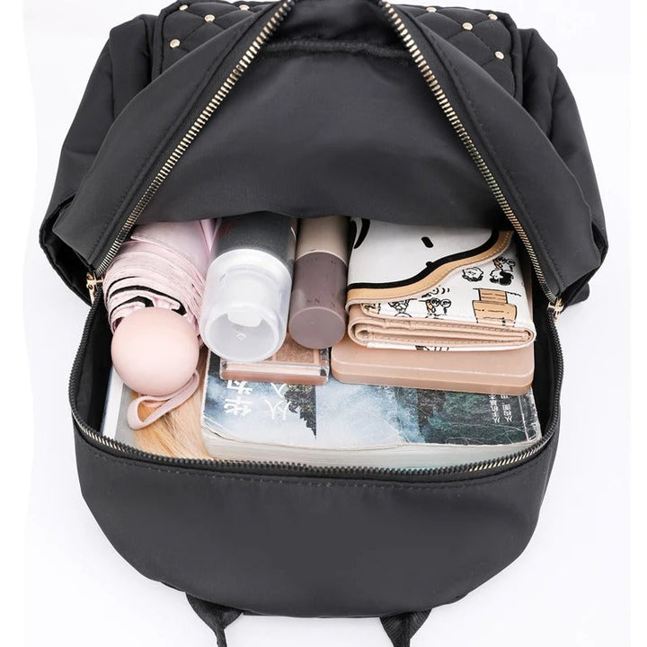 Versatile women's water-resistant nylon backpack; a lightweight travel bag or school essential.