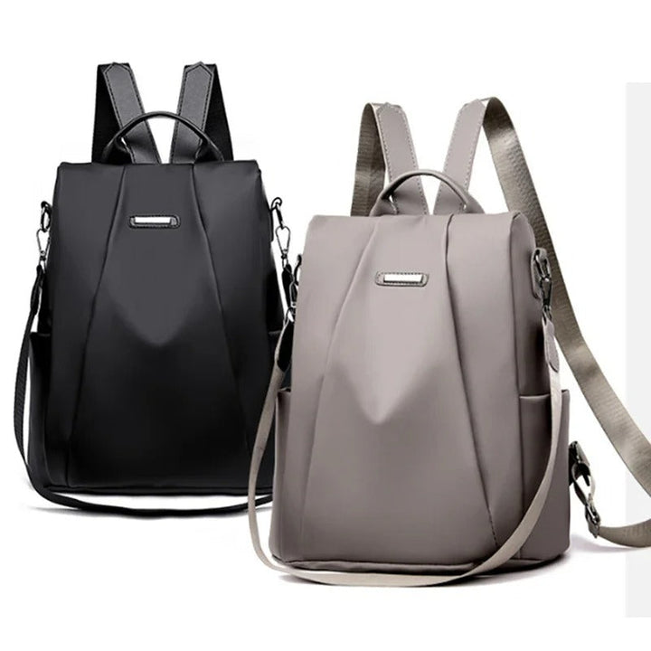 Close-up of the premium water-resistant nylon fabric of a women's multi-way lightweight everyday bag.