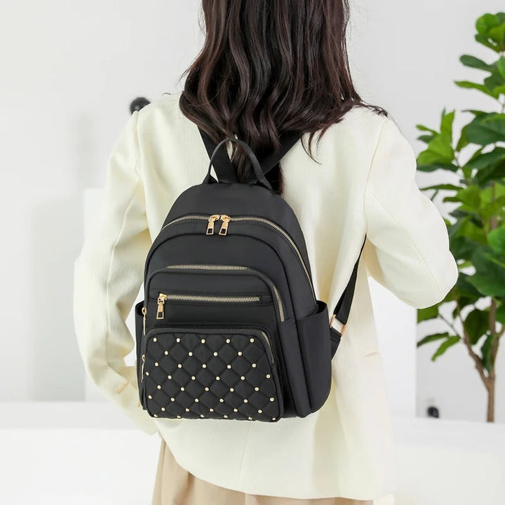 Front view of khaki lightweight water-resistant nylon women's backpack, perfect for daily use.