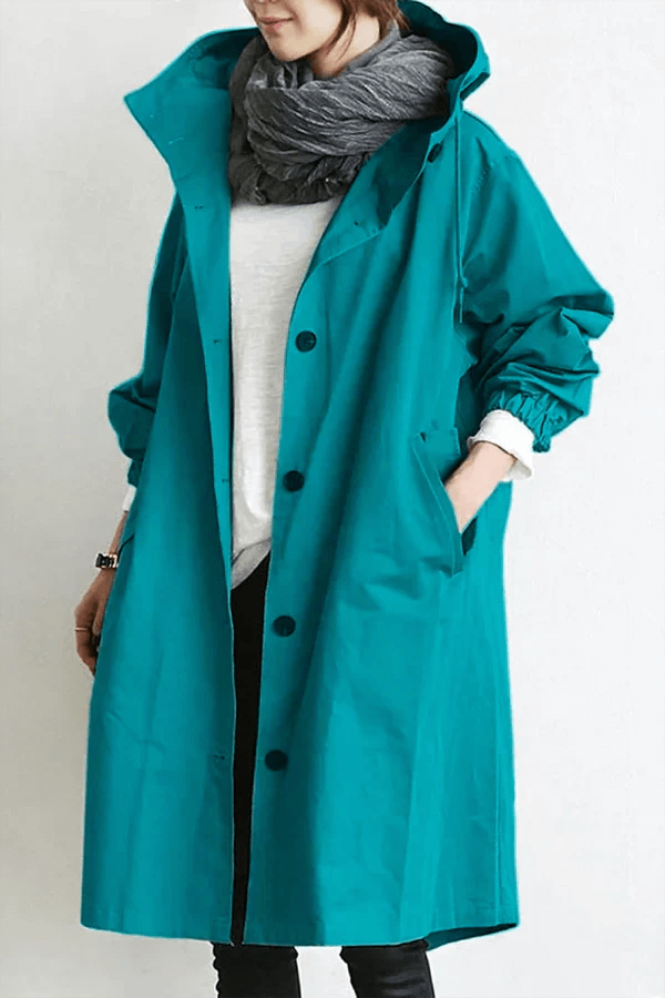 Women's lightweight waterproof rain cape, perfect for travel & all-weather protection. Stylish outerwear.
