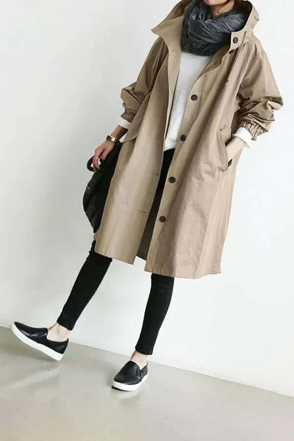 Travel-friendly women's lightweight rain cape. Waterproof jacket for stylish all-weather coverage.