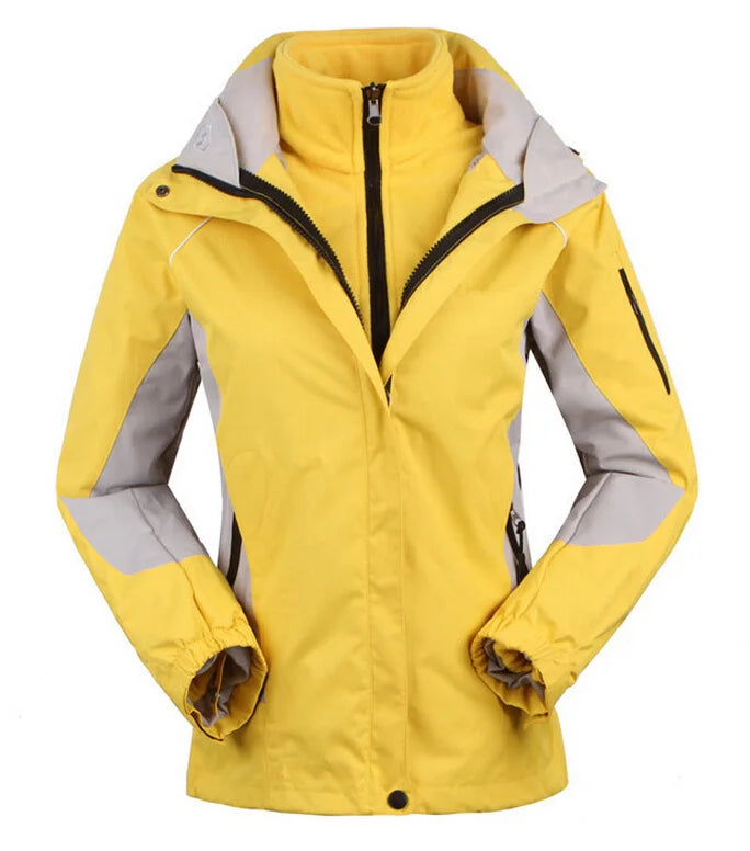 Detail of the waterproof zippers on a women's windbreaker, emphasizing its rain jacket functionality.