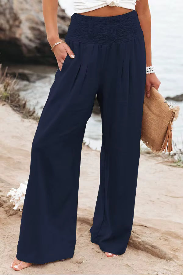 Full shot of woman wearing comfortable wide leg linen trousers, perfect for summer ease.