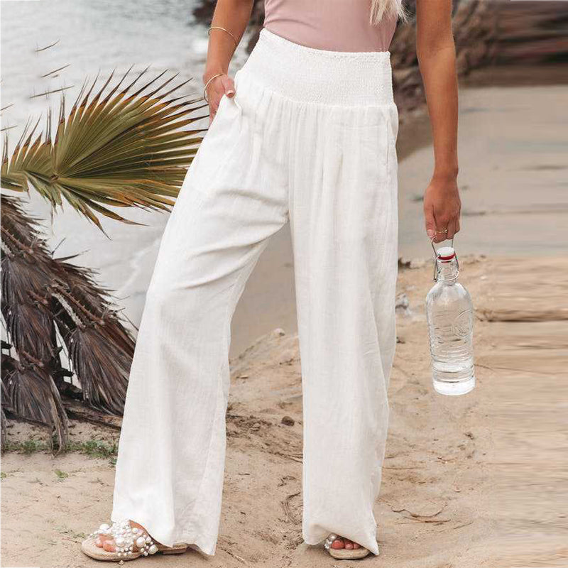Elegant women's wide leg linen trousers with a smocked waist, ideal for casual summer style.