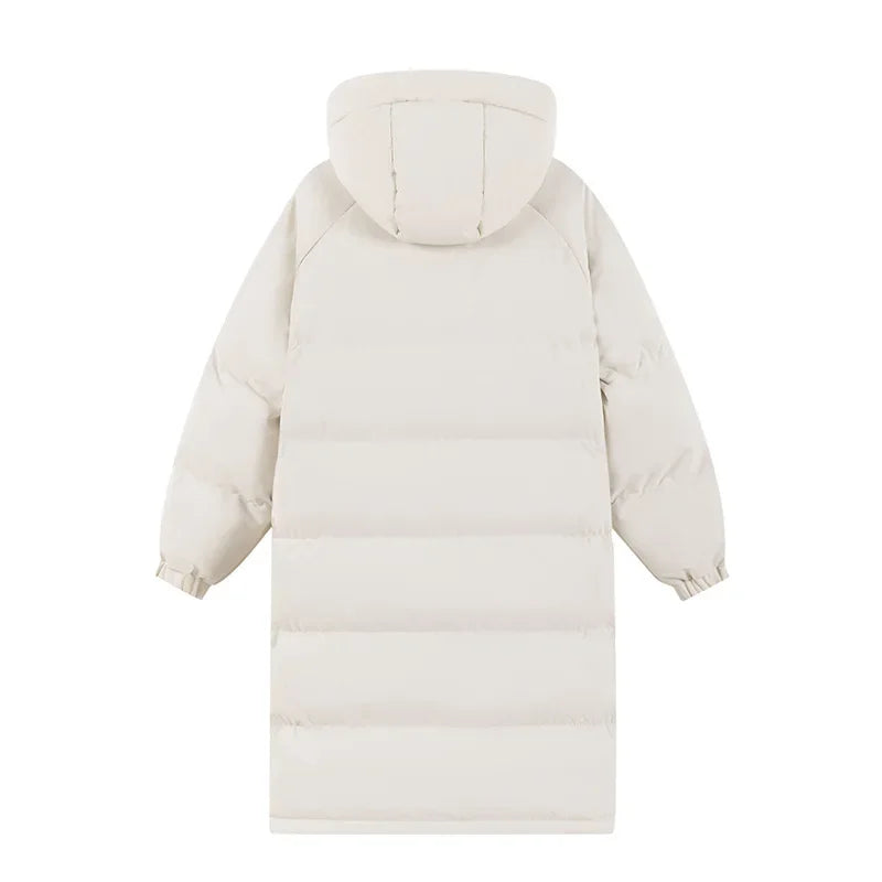 Stylish woman on a snowy mountain wearing a long blue puffer ski jacket, ideal for winter sports